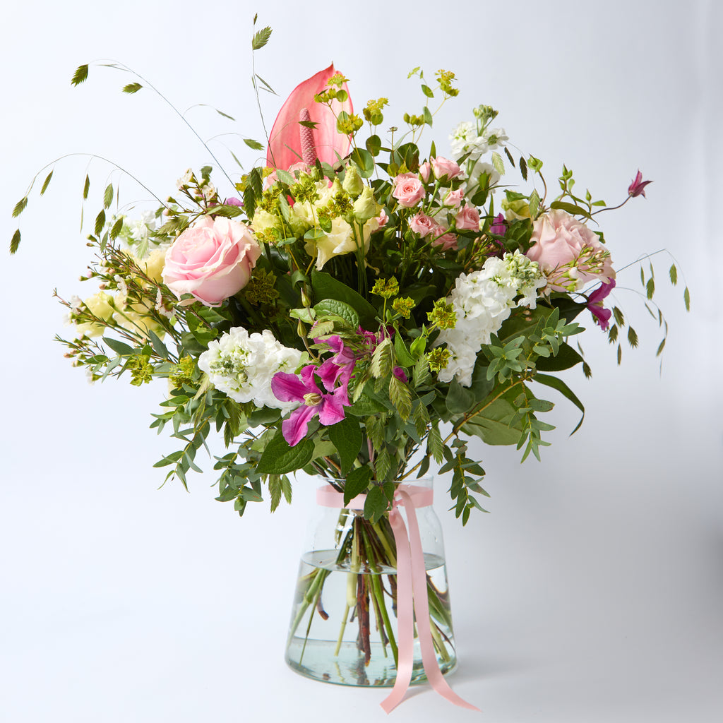 Just Between Friends (Lisianthus / Clematis / Stocks / Roses / Spray Rose / Waxflower / Anthurium / Chasmanthium / Eucalyptus / Bupleurem)