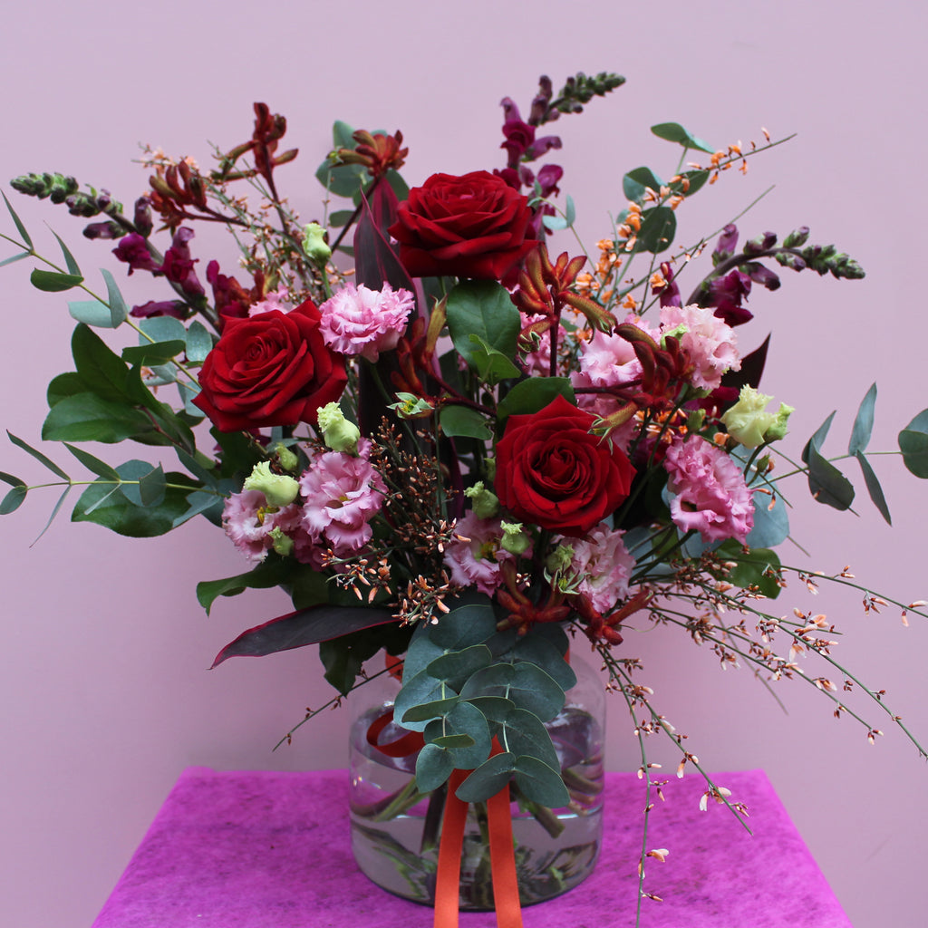 Love Actually (A combination of reds, oranges and pinks including roses, kangaroo paw, lisianthus and snapdragons)