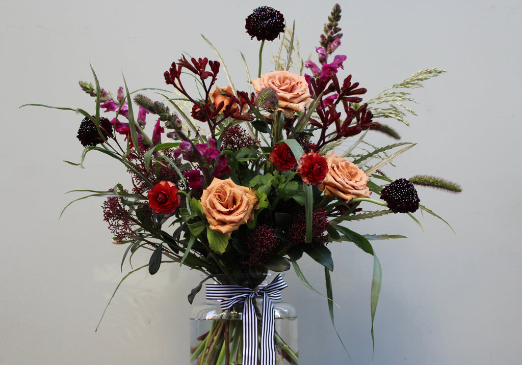 The Devil Wears Prada (A dark and luxurious bouquet with toffee roses, scabious, ranunculus, kangaroo paw, antirrhinum and grasses)