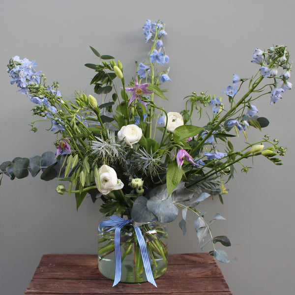 Wonder Woman (Whimsical vibes with this one. A mix of delicate delphinium, clematis, freesia and ranunclulus in pale blue, purple and white.)