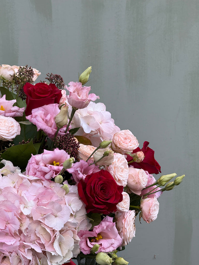 One Day (Full on Valentine's Day vibes with this bouquet in pinks and reds including mixed roses, hydrangea and lisianthus)