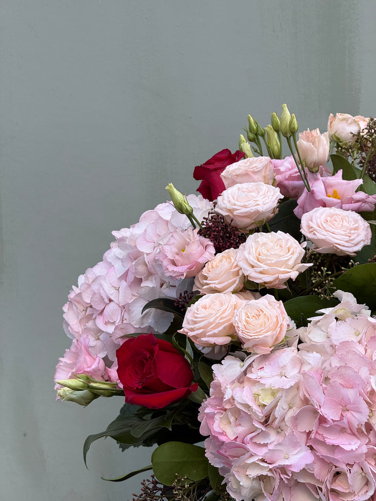 One Day (Full on Valentine's Day vibes with this bouquet in pinks and reds including mixed roses, hydrangea and lisianthus)