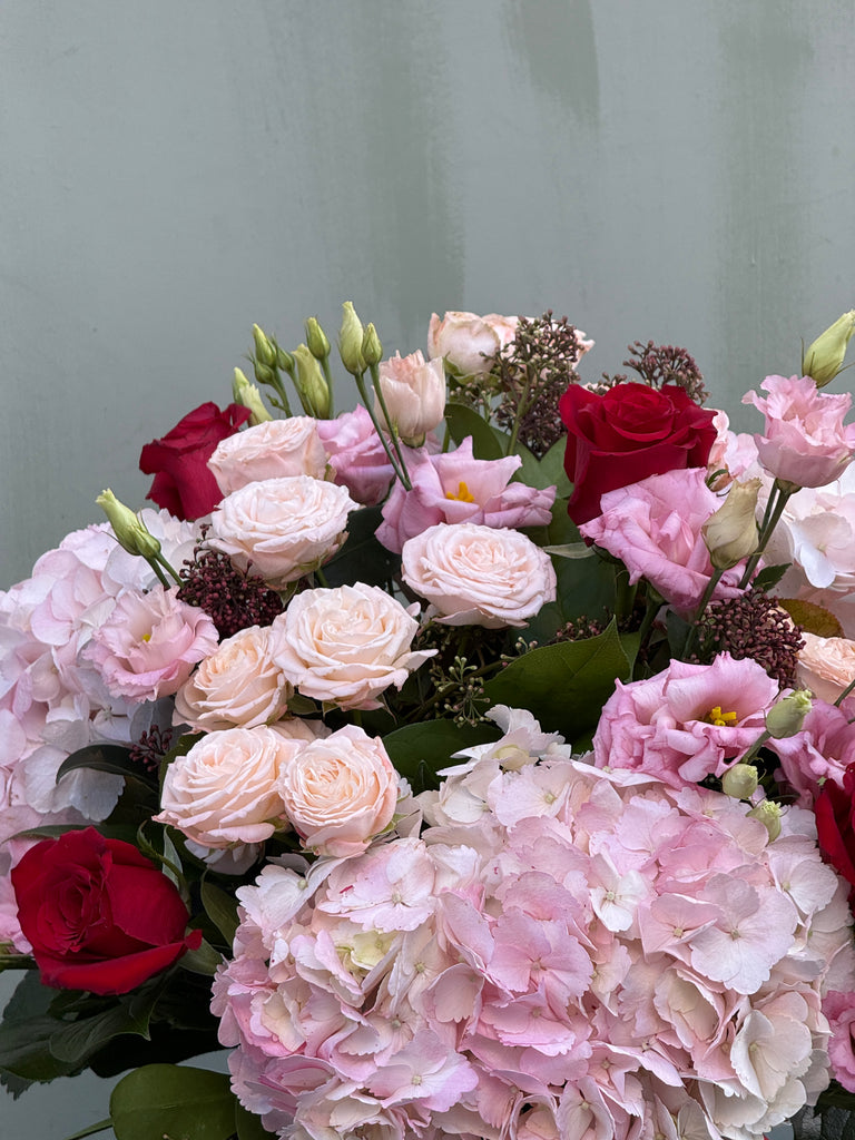 One Day (Full on Valentine's Day vibes with this bouquet in pinks and reds including mixed roses, hydrangea and lisianthus)