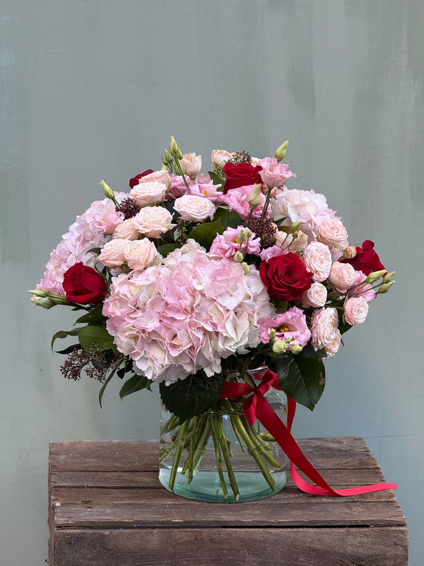 One Day (Full on Valentine's Day vibes with this bouquet in pinks and reds including mixed roses, hydrangea and lisianthus)