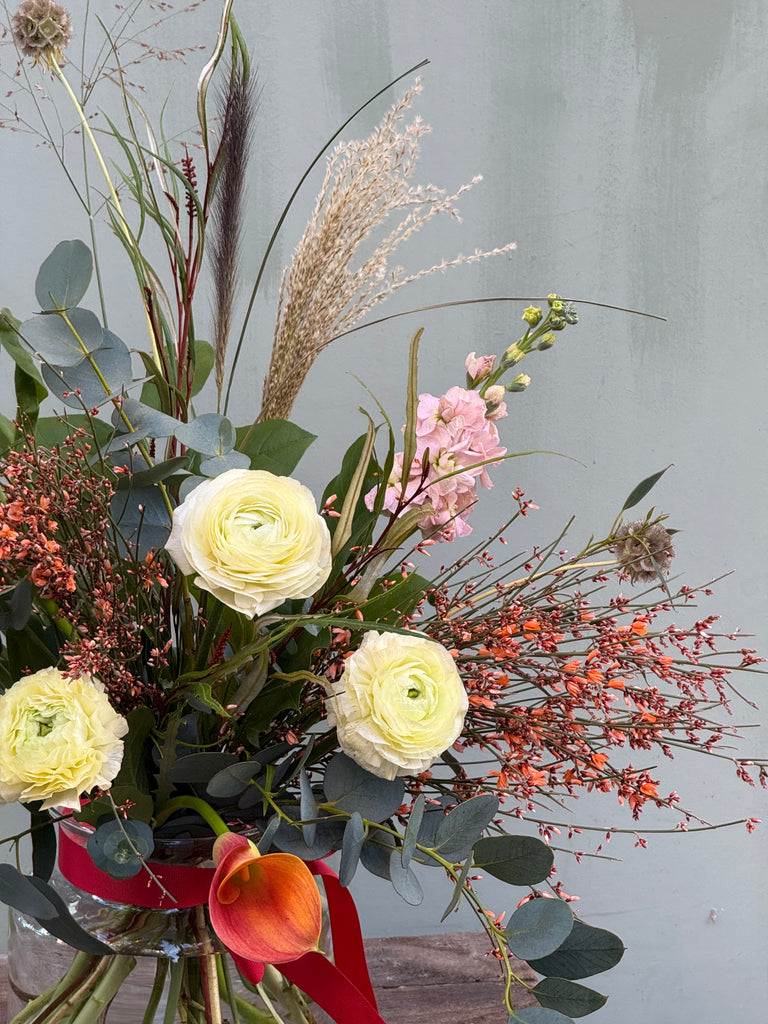 Gone With the Wind (A whimsical beauty containing ranunculus, scented stocks, genista, calla lily and a variety of grasses)