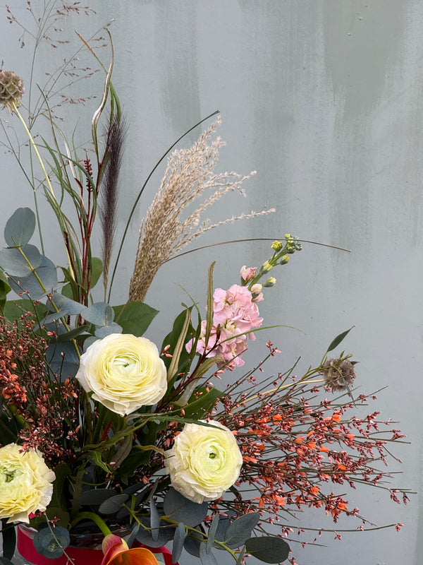Gone With the Wind (A whimsical beauty containing ranunculus, scented stocks, genista, calla lily and a variety of grasses)