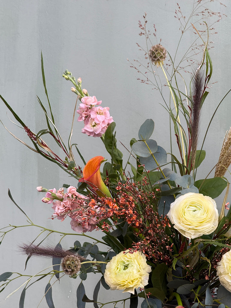 Gone With the Wind (A whimsical beauty containing ranunculus, scented stocks, genista, calla lily and a variety of grasses)