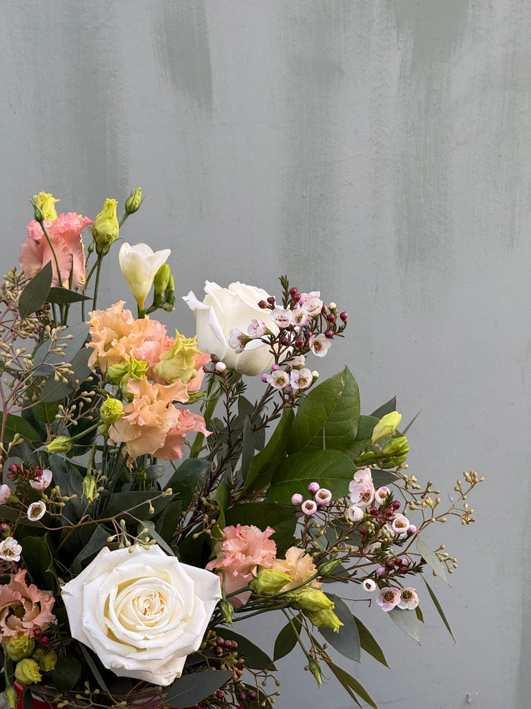 Breakfast at Tiffany's (A classic combination roses, freesia, lisianthus, waxflower and anthurium in whites and pale pinks)