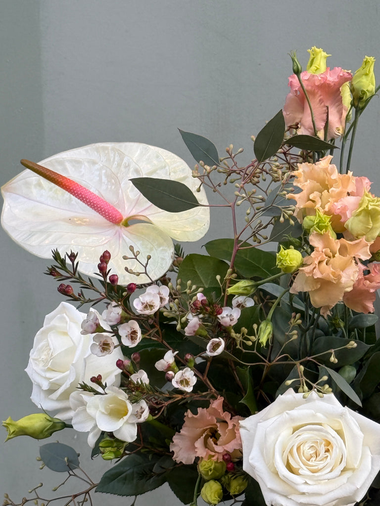 Breakfast at Tiffany's (A classic combination roses, freesia, lisianthus, waxflower and anthurium in whites and pale pinks)